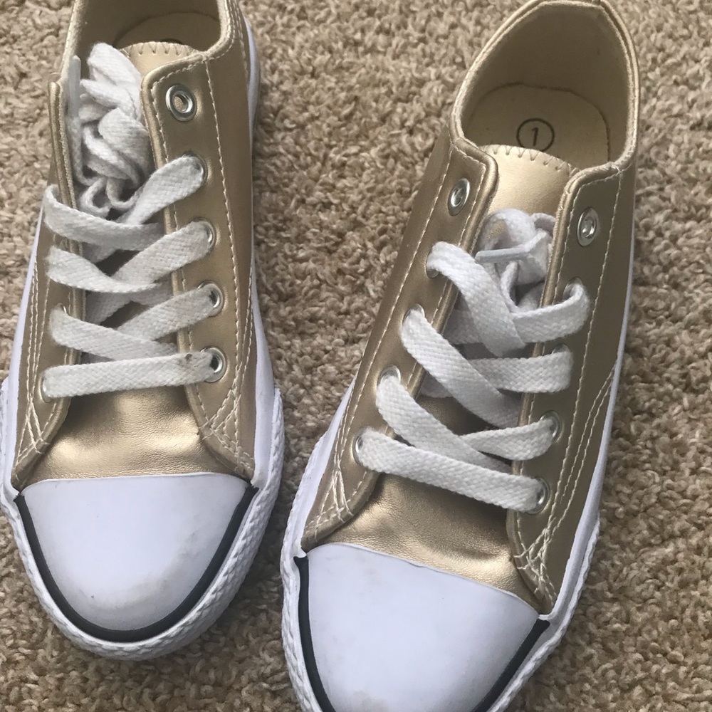 Gold and white tennis shoes